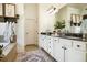 Bright bathroom with dual sinks, granite counters, and white cabinets at 3227 Aviary Nw Ct, Acworth, GA 30101