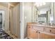 Bright bathroom with a large vanity and a tiled shower featuring a striped curtain at 3227 Aviary Nw Ct, Acworth, GA 30101