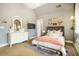 Bright bedroom featuring a white dresser with a decorative mirror, colorful rug, and unique decorative wall hangings at 3227 Aviary Nw Ct, Acworth, GA 30101