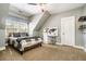 Comfortable bedroom with a ceiling fan, large window, desk, and a decorative world map displayed on the wall at 3227 Aviary Nw Ct, Acworth, GA 30101