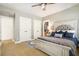 Comfortable bedroom with a ceiling fan, plush carpet, and a large decorative headboard at 3227 Aviary Nw Ct, Acworth, GA 30101