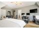Spacious bedroom with carpet, ceiling fan, and multiple monitors on desk at 3227 Aviary Nw Ct, Acworth, GA 30101
