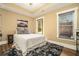 Cozy bedroom features tray ceilings, a large window, and neutral decor at 3227 Aviary Nw Ct, Acworth, GA 30101