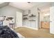Bedroom featuring a bed, desk, floating shelves, a light gray paint color, and a view into the bathroom at 3227 Aviary Nw Ct, Acworth, GA 30101