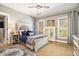 Inviting bedroom with a large bed, accent pillows, and natural light from two large windows at 3227 Aviary Nw Ct, Acworth, GA 30101