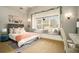 Cozy bedroom featuring a daybed, a large sunny window seat, and decorative wall hangings at 3227 Aviary Nw Ct, Acworth, GA 30101