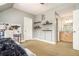 Another angle of the cozy bedroom with shelving and adjacent ensuite bathroom at 3227 Aviary Nw Ct, Acworth, GA 30101
