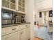 Butler's pantry with glass cabinets, granite countertops, and stainless steel appliances adjacent to the dining area at 3227 Aviary Nw Ct, Acworth, GA 30101