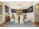 Formal dining room featuring elegant decor, wainscoting, a stylish light fixture, and a blue accent wall at 3227 Aviary Nw Ct, Acworth, GA 30101