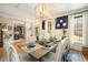 Elegant dining room featuring a coffered ceiling, designer lighting, and classic decor for sophisticated gatherings at 3227 Aviary Nw Ct, Acworth, GA 30101