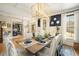 An elegant dining room features wainscoting, designer lighting, and a beautifully set table for entertaining at 3227 Aviary Nw Ct, Acworth, GA 30101