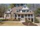 Charming two-story home features a welcoming front porch, landscaped yard, and a blend of stone and siding accents at 3227 Aviary Nw Ct, Acworth, GA 30101