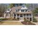 Charming two-story home featuring a welcoming front porch, stone accents, and manicured landscaping at 3227 Aviary Nw Ct, Acworth, GA 30101