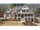 Beautiful two-story home featuring a welcoming front porch and manicured landscaping at 3227 Aviary Nw Ct, Acworth, GA 30101
