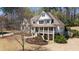 Stately two-story home with a charming front porch nestled among mature trees at 3227 Aviary Nw Ct, Acworth, GA 30101