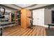 Home gym featuring a wood sauna, gym equipment, light gray paint, and hardwood flooring at 3227 Aviary Nw Ct, Acworth, GA 30101