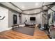 Home gym with hardwood flooring, workout equipment, wall decal, and neutral colored walls at 3227 Aviary Nw Ct, Acworth, GA 30101