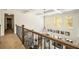 Open hallway overlooking the living room with large windows and lots of natural light at 3227 Aviary Nw Ct, Acworth, GA 30101