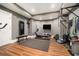 Home gym with modern exercise equipment, hardwood floors, a mirrored wall, and motivational wall decor at 3227 Aviary Nw Ct, Acworth, GA 30101
