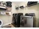 Laundry room with new stainless-steel front-loading washer and dryer and ample shelving at 3227 Aviary Nw Ct, Acworth, GA 30101