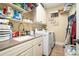 Bright laundry room with a sink, white cabinets, and a modern washer and dryer set at 3227 Aviary Nw Ct, Acworth, GA 30101