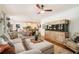 Spacious living room featuring a large sectional sofa, a wooden fish tank, and decorative lighting fixtures at 3227 Aviary Nw Ct, Acworth, GA 30101