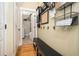 Organized mudroom with storage baskets, a bench, hooks, and access to the laundry room at 3227 Aviary Nw Ct, Acworth, GA 30101