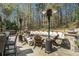 Backyard with stone patio, complete with wood burning fire pit, a built in seating area, and stylish outdoor heaters at 3227 Aviary Nw Ct, Acworth, GA 30101