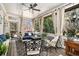 Screened-in porch with comfortable seating, a ceiling fan, and views of the surrounding trees and nature at 3227 Aviary Nw Ct, Acworth, GA 30101
