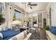 Relaxing screened porch features a hanging daybed, neutral color palette, and a beautiful view of the lush backyard at 3227 Aviary Nw Ct, Acworth, GA 30101