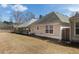 View of the back of the home and grassy backyard at 4927 Magnolia Cottage Way, Acworth, GA 30101