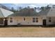 View of the back of the home and grassy backyard at 4927 Magnolia Cottage Way, Acworth, GA 30101