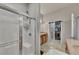 Bright bathroom featuring a tiled shower with glass door and a walk-in closet at 4927 Magnolia Cottage Way, Acworth, GA 30101