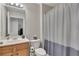 Neat bathroom features a light wood vanity and a shower with a curtain at 4927 Magnolia Cottage Way, Acworth, GA 30101