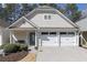 Charming home featuring a two-car garage, neutral siding, and well-maintained landscaping at 4927 Magnolia Cottage Way, Acworth, GA 30101