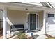 Welcoming front porch features classic columns, a bench, and a secure SimpliSafe system at 4927 Magnolia Cottage Way, Acworth, GA 30101