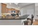 Bright kitchen featuring wood cabinetry, granite counters, stainless appliances and bar stool seating at 4927 Magnolia Cottage Way, Acworth, GA 30101