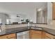 Open kitchen boasts stainless steel appliances, granite counters, and seamless flow to the living space at 4927 Magnolia Cottage Way, Acworth, GA 30101