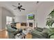 Comfortable living room features a fireplace, a ceiling fan, and hardwood floors at 4927 Magnolia Cottage Way, Acworth, GA 30101
