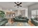 Cozy living room featuring hardwood floors, a ceiling fan, and an open layout to the kitchen at 4927 Magnolia Cottage Way, Acworth, GA 30101