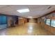 Spacious basement with wood paneling, a staircase, tile flooring, and natural light from windows at 993 Castle Falls Dr. Ne Dr, Atlanta, GA 30329