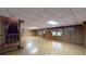 Expansive basement area featuring wood-paneled walls, tile flooring, staircase, and natural light at 993 Castle Falls Dr. Ne Dr, Atlanta, GA 30329