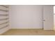 A simple carpeted bedroom features built in shelving and a closet space at 993 Castle Falls Dr. Ne Dr, Atlanta, GA 30329