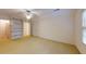 Large bedroom with neutral carpet, ceiling fan, a built-in bookshelf, and natural light at 993 Castle Falls Dr. Ne Dr, Atlanta, GA 30329