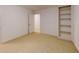 A carpeted bedroom has a large built-in bookcase and a door to another room at 993 Castle Falls Dr. Ne Dr, Atlanta, GA 30329