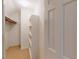 White walk-in closet with built-in shelves, hanging rods, and a door leading to another space at 993 Castle Falls Dr. Ne Dr, Atlanta, GA 30329