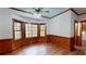 Dining room with wood-paneled walls, large windows offering natural light and wooded view, and hardwood floors at 993 Castle Falls Dr. Ne Dr, Atlanta, GA 30329