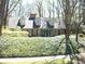 Charming brick home featuring dormer windows, a well-maintained lawn, and lush landscaping at 993 Castle Falls Dr. Ne Dr, Atlanta, GA 30329
