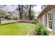 Well-maintained front yard with green lawn, colorful flowerbeds, and lush landscaping at 993 Castle Falls Dr. Ne Dr, Atlanta, GA 30329