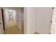 A long hallway with neutral walls and carpeted flooring connects multiple rooms at 993 Castle Falls Dr. Ne Dr, Atlanta, GA 30329